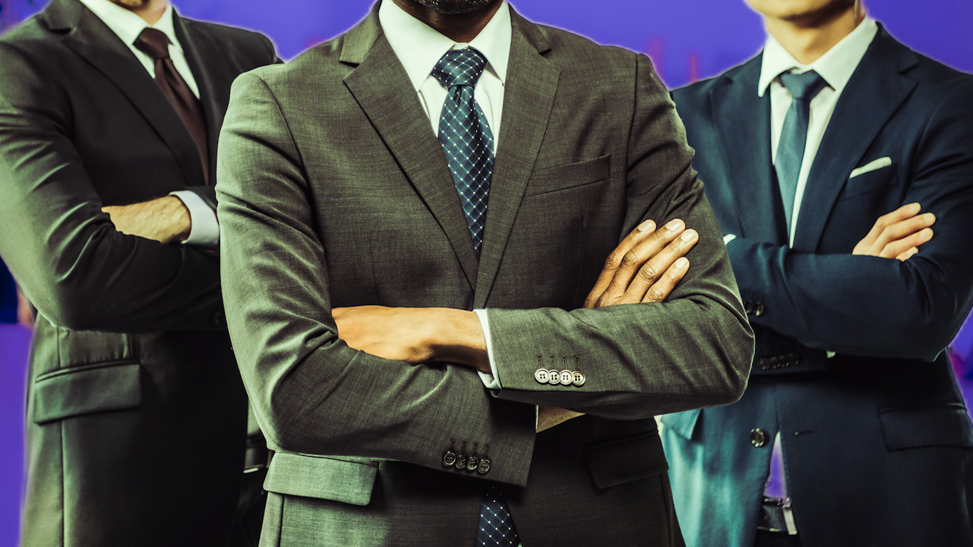 group of multiethic businessmen with folded arms looking at camera